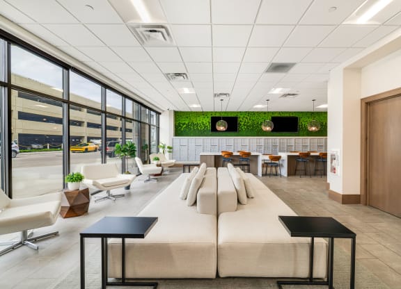 a large lobby with couches and chairs and a table with chairsat Northern Lights a Lifestyle-Driven Community, West Fargo, North Dakota