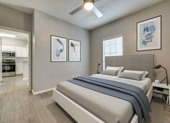a bedroom with a bed and a ceiling fan at Foxborough Apartments, Irving, TX, Texas, 75061