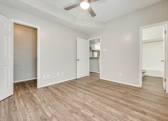an empty living room with a wood floor and a ceiling fan at Foxborough Apartments, Irving, TX, Texas, 75061