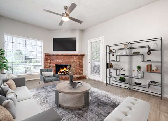 an open living room with a fireplace and a ceiling fan at Foxborough Apartments, Irving, TX, Texas, 75061