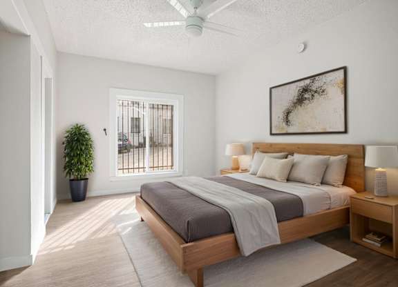 A bedroom with a large bed and a ceiling fan at Hillstone Flats Apartments, Los Angeles, CA