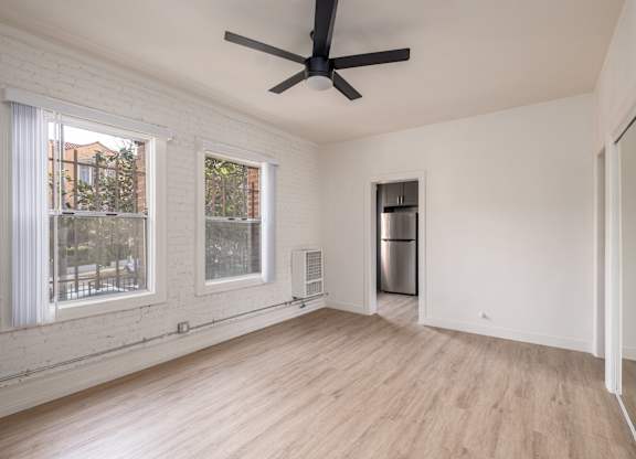 A room with a ceiling fan and a refrigerator at Kenmore Park Apartments, Los Angeles, 90004