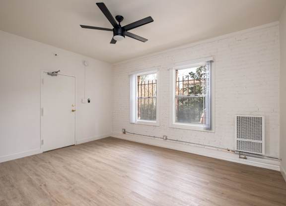 A room with a ceiling fan and a window at Kenmore Park Apartments, Los Angeles