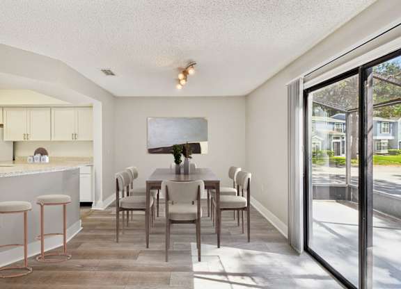 A kitchen with a bar area and a dining table.