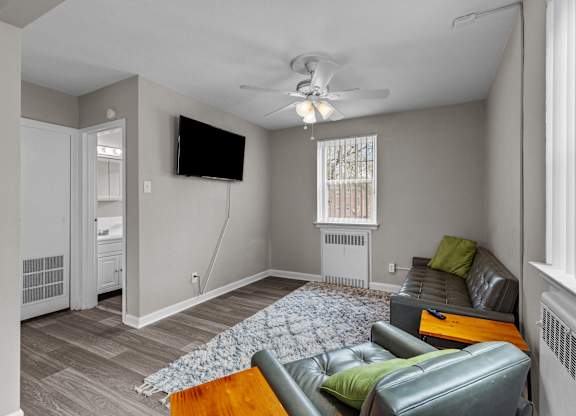 a living room with a couch and a tv at Hampton Gardens, Missouri, 63139