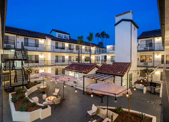 a view of the courtyard of a hotel at night