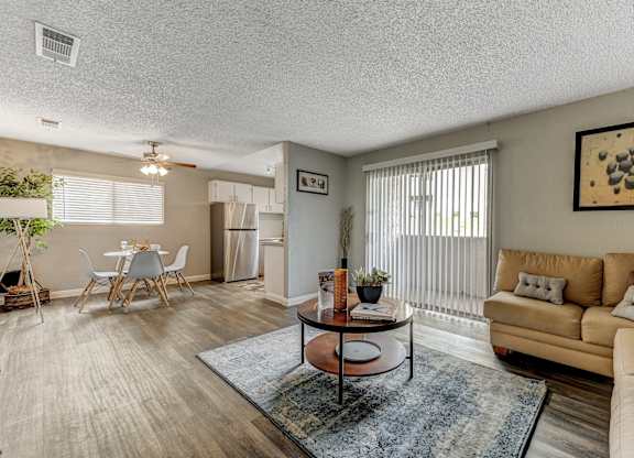 a living room with a couch and a table and a kitchen at Desert Bay Apartments, Laughlin,89029