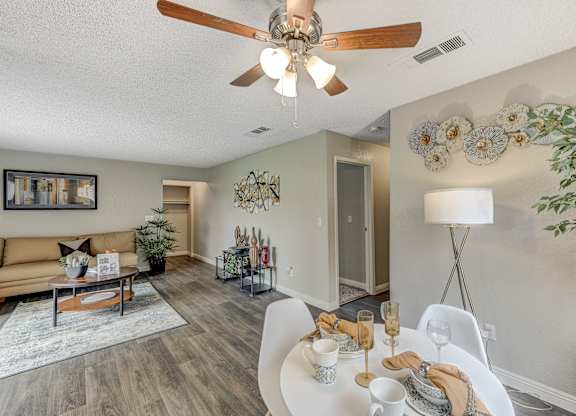 our living room and dining room are spacious and modern with a ceiling fan at Desert Bay Apartments, Laughlin,89029