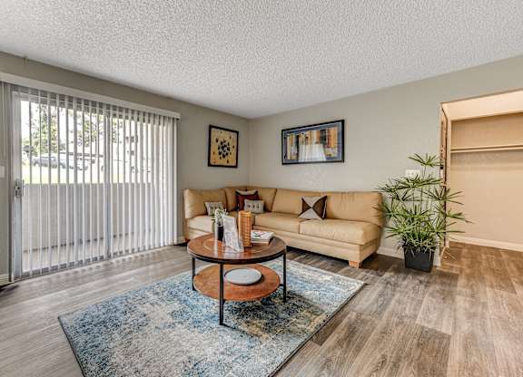 a living room with a couch and a sliding glass door at Desert Bay Apartments, Laughlin, Nevada, 89029