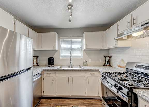 an updated kitchen with white cabinets and stainless steel appliances at Desert Bay Apartments, Laughlin, NV, 89029
