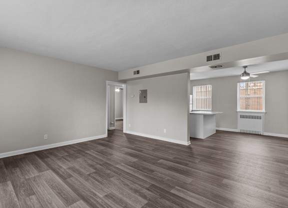 Living room and dining room of an empty house with wood flooring at Hampton Gardens, Missouri, 63139