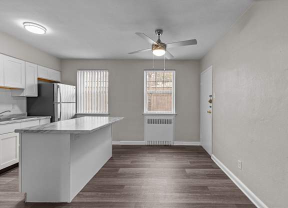 an empty kitchen with an island and a ceiling fan at Hampton Gardens, Missouri, 63139