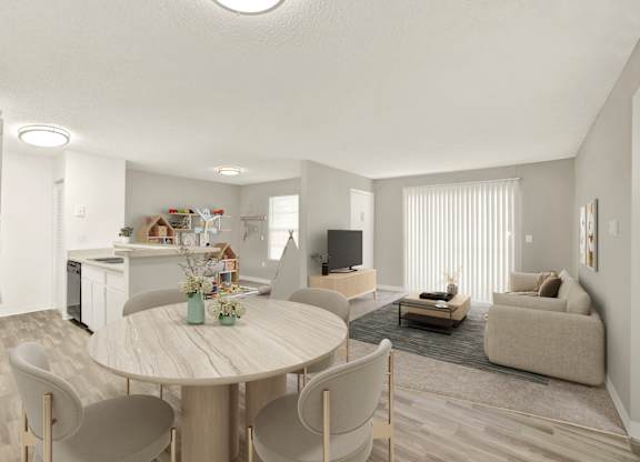 A modern living room with a dining table and chairs.