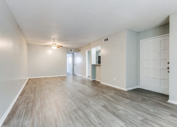 the spacious living room and dining room of an apartment at Falls on Clearwood Apartments, Richardson, TX, Texas