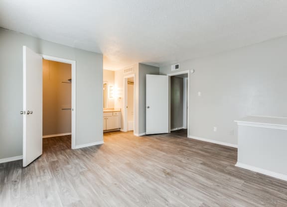 an empty living room with wood flooring and white walls at Falls on Clearwood Apartments, Richardson, TX, Texas