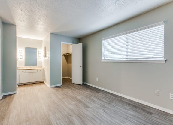 an empty living room with a bathroom and a window at Falls on Clearwood Apartments, Richardson, TX, Texas