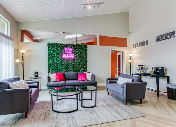 a living room with couches and chairs and a green wall at Falls on Clearwood Apartments, Richardson, TX, Texas