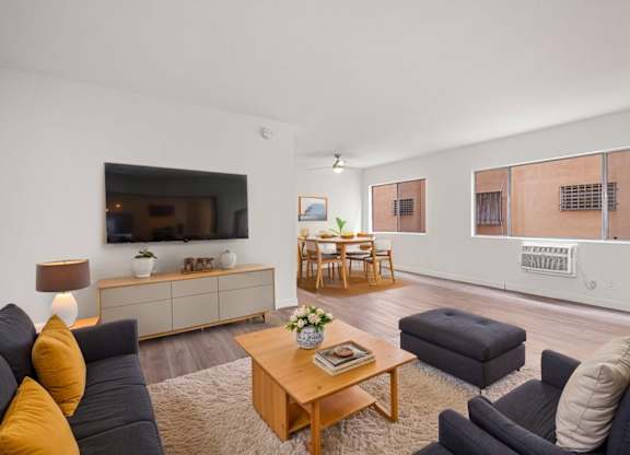 A living room with a grey couch and a wooden coffee table.
