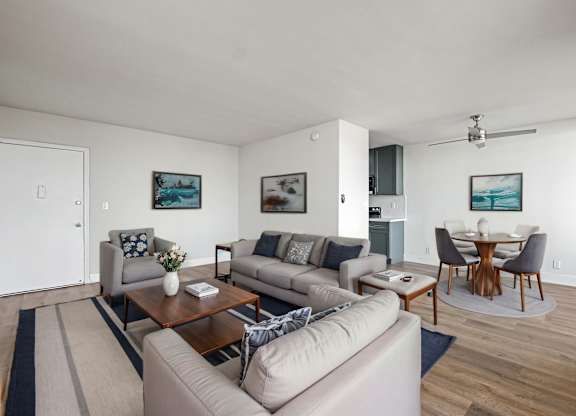 A living room with a grey couch and a coffee table.