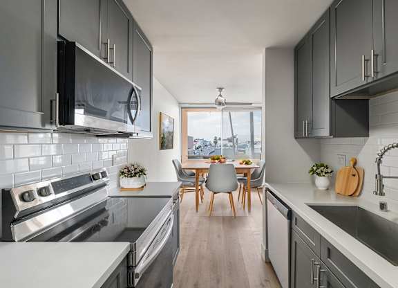 A modern kitchen with a dining table and chairs.