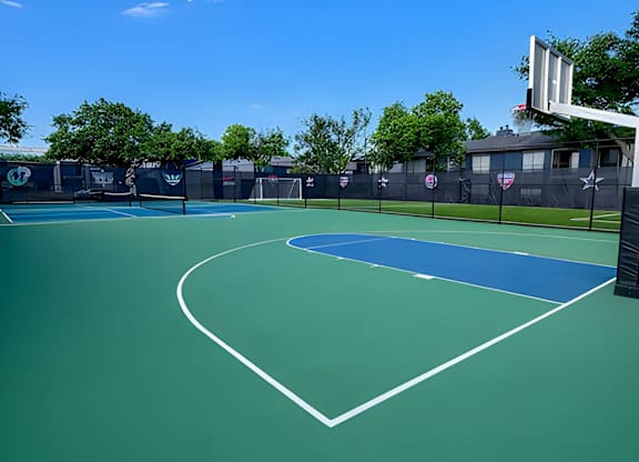 A basketball court with a net and a basketball hoop.