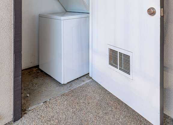 a white refrigerator and freezer in a room with a door
