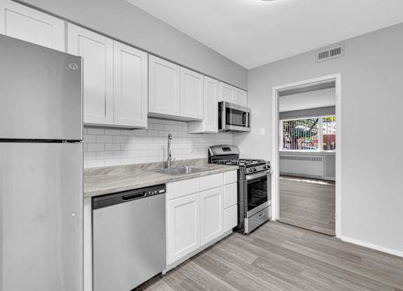 a kitchen with white cabinets and Refrigerator at Hampton Gardens, Missouri, 63139
