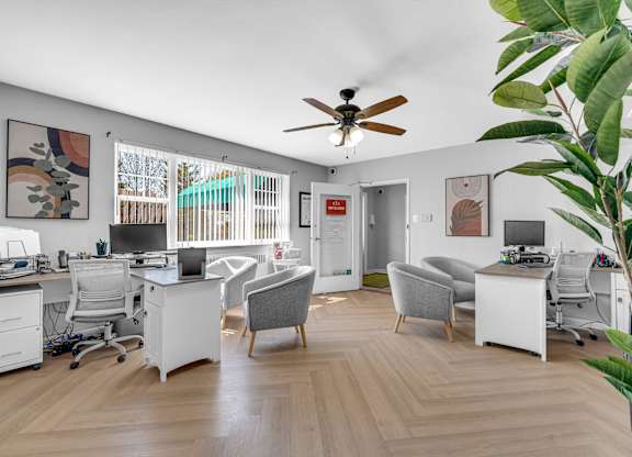 a room with two desks and two chairs and a ceiling fan at Hampton Gardens, Missouri
