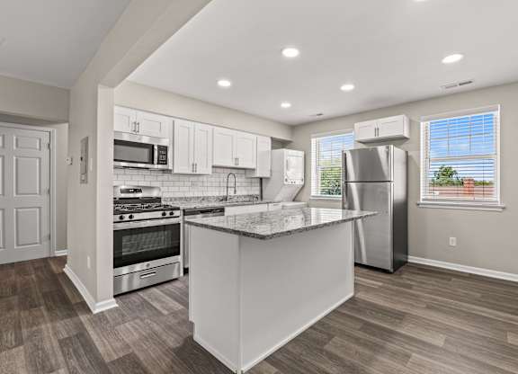a kitchen with a large island and stainless steel appliances at Hampton Gardens, Missouri
