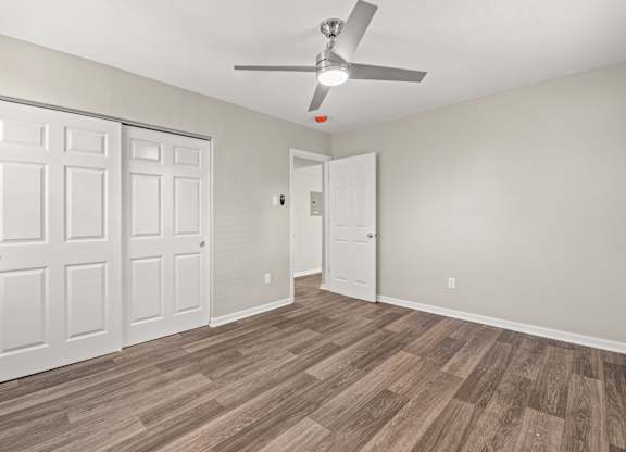 a bedroom with hardwood flooring and a ceiling fan at Hampton Gardens, Saint Louis, Missouri