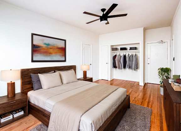 A bedroom with a large bed and a ceiling fan at Kenmore Park Apartments, Los Angeles, CA, 90004