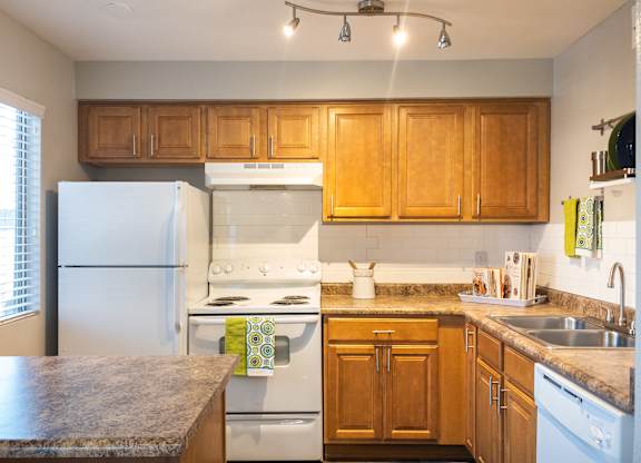 a kitchen with white appliances and wooden cabinets at Granite Bay, Phoenix, Arizona, 85023