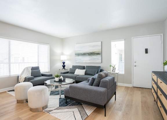 a living room with a couch and a chair and a table