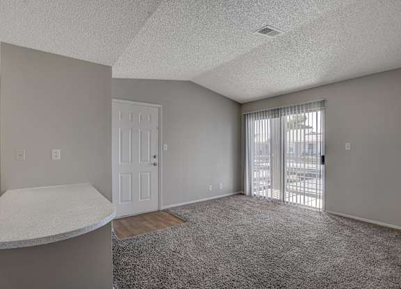 A room with a white door and a window with blinds.