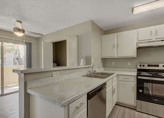 A kitchen with a stove, oven, and cabinets.