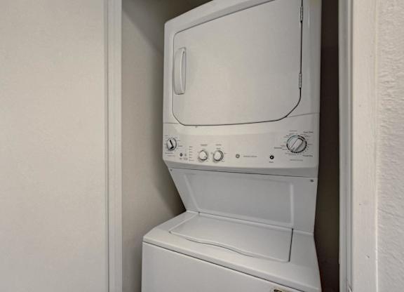 A white washing machine in a small space.