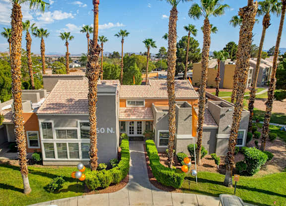 A building with palm trees in front of it.