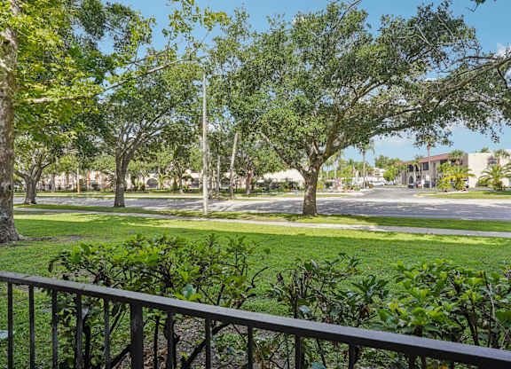 A view of a green lawn from a balcony.