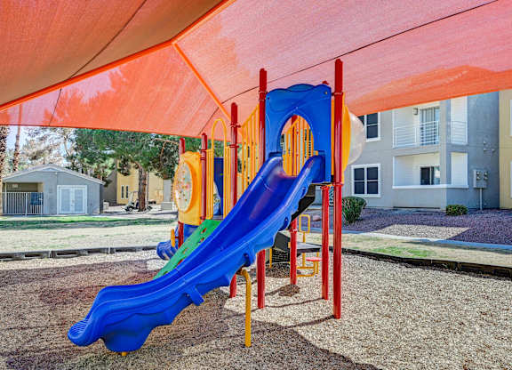 A blue and yellow slide in a playground.