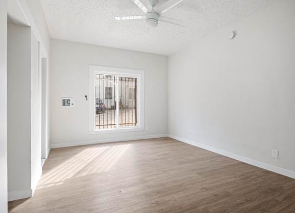 A room with a window and a fan on the ceiling at Hillstone Flats Apartments, Los Angeles