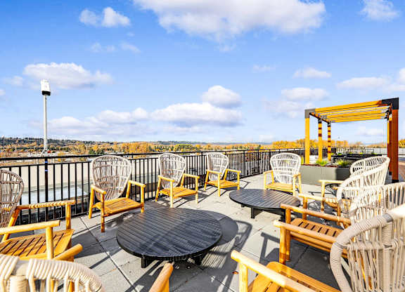 A patio with a table and chairs overlooking a city.