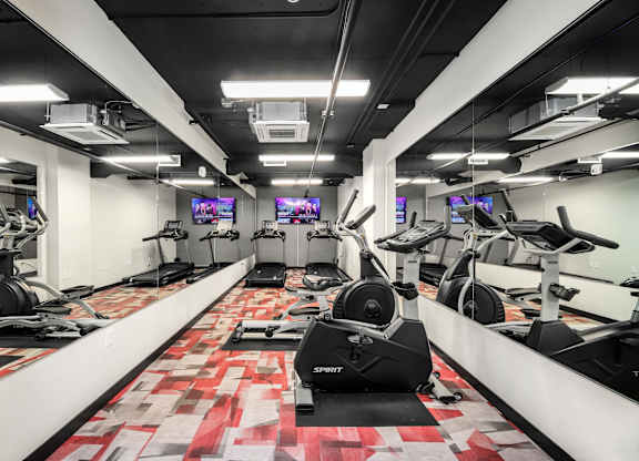 A gym with treadmills and exercise bikes.