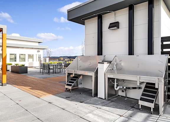 A machine is on a patio outside a building.