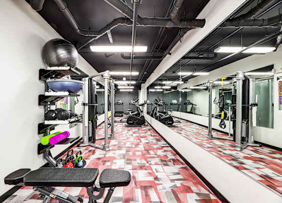 A gym with a red and white checkered floor.