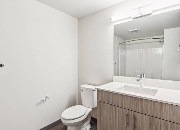 A white toilet sits next to a sink in a bathroom.
