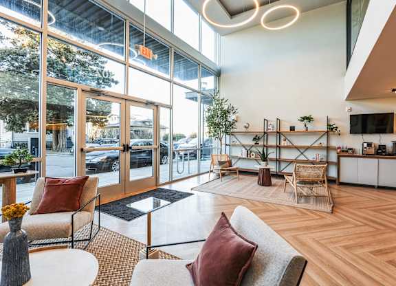A modern living room with a couch, chairs, and a coffee table.