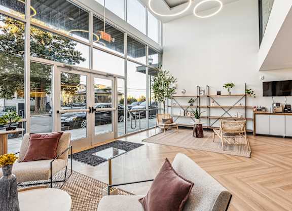 A modern living room with a glass door entrance.