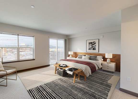 A bedroom with a bed, nightstand, and chair.