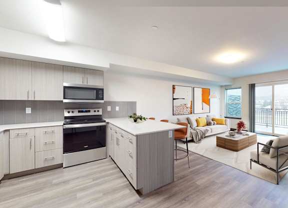 A modern kitchen with a dining area and a balcony.