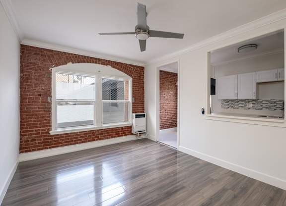 A room with a ceiling fan and a window at Mariposa Willows Apartments, Los Angeles, CA, 90004